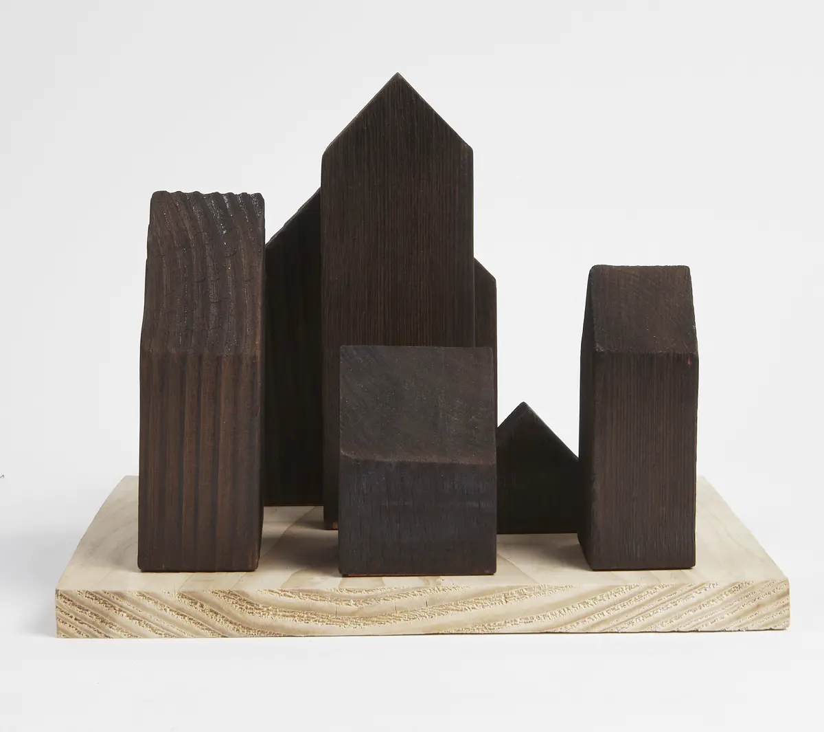 Lichen as bioindicators

Lichen Vs Carbon. These concept models look to document both the current state of Dudley Highstreet and the vision looking towards the future within this thesis project.

The lichen covered model looks towards a future in Dudley that is rich in texture, colour, nature and oxygen. Natural materials promote natural growth, and textures such as rough sawn timber and stone are the prefect hosts for lichen. All new buildings in Dudley would benefit massively from following a fabric first approach and adopt the use of sustainable and recycled building materials along with systems that use minimal energy.

The lichen model represents a vision for this thesis, buildings that are covered in natural materials and lichens that help sequester carbon and promote a healthier Highstreet. Suggestions of raised buildings also proposes less disruption to the ground and natural landscape, giving plants and animals the opportunity to thrive in an otherwise hostile concrete environment. Raised buildings also look towards a future planet with rising sea levels, future factors that will drastically affect the way we carry out daily lives and futureproofing all buildings for generations to come.

This second model uses the Shou Sugi Ban method of charring timber to waterproof it. In this case however it represents the embodied carbon and pollution within the highstreet as it exists now. The simplicity and repetition is also used to symbolise the plain nature of the highstreet with only a few materials exhibited, mainly brick & concrete. Once burnt the timber forms were brushed with wire wool to reveal the natural grain of the wood, a visual representation of degradation of layers of buildings that are built poorly or not constructed to last longer than a generation. - Michelle Gartside Model 8.png